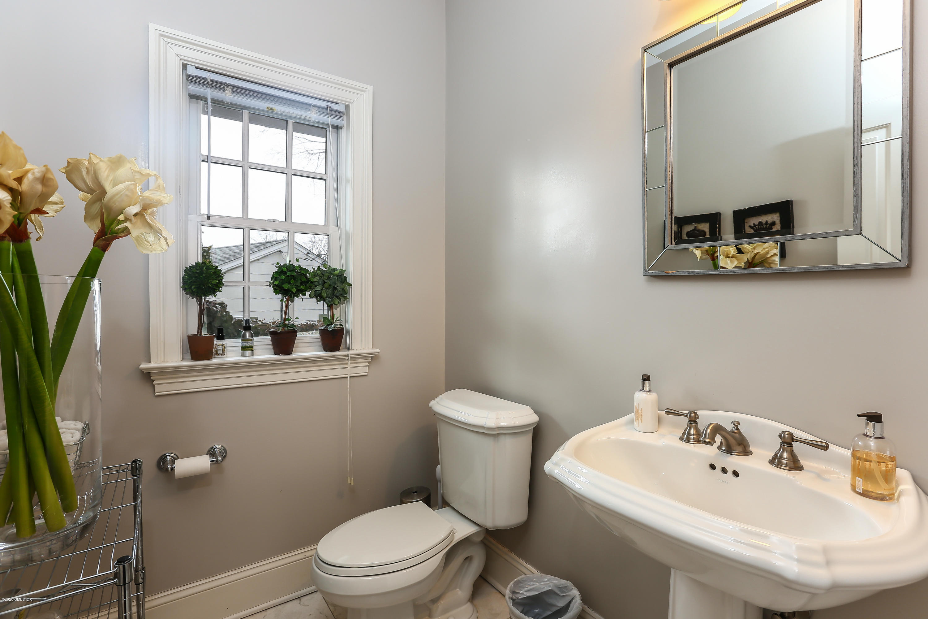 59 Riverside Lane Riverside, CT 06878 - Photo 10 of 21 a bathroom with a sink a toilet and mirror