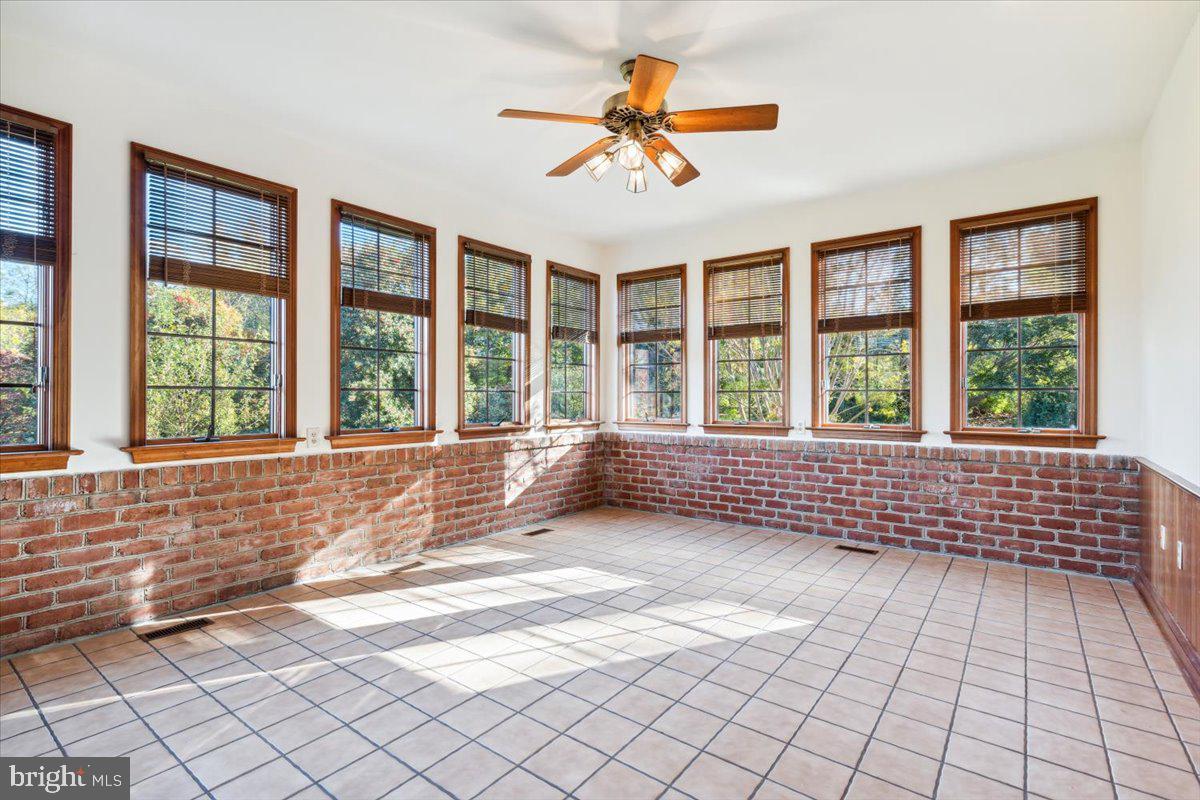 7130 Ira Sears Road Adamstown, MD 21710 - Photo 22 of 70 Relax in the sunroom with panoramic windows.