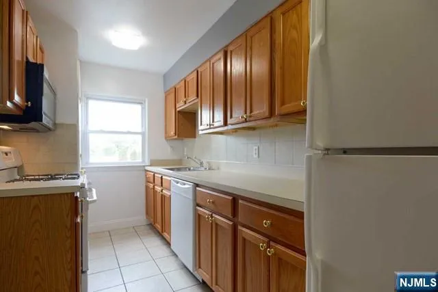 a kitchen with stainless steel appliances granite countertop a sink stove and microwave