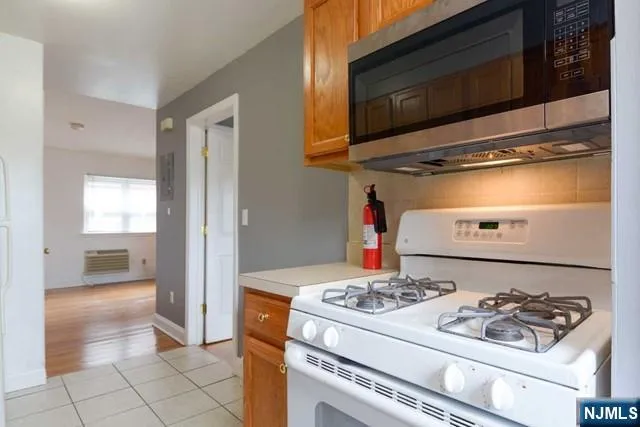 a stove top oven sitting inside of a kitchen