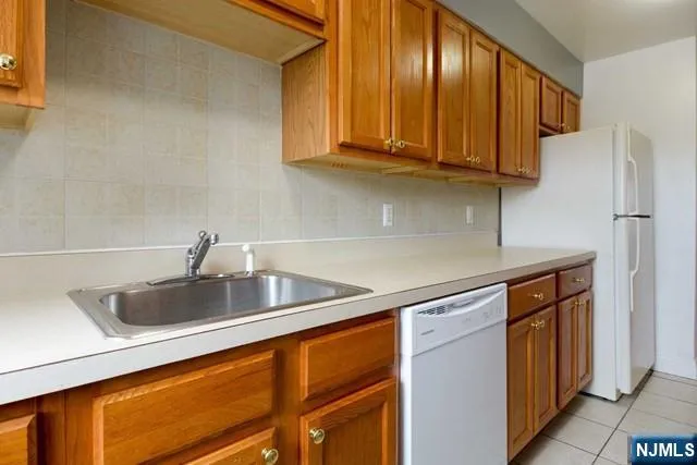 a kitchen with stainless steel appliances granite countertop a sink and cabinets