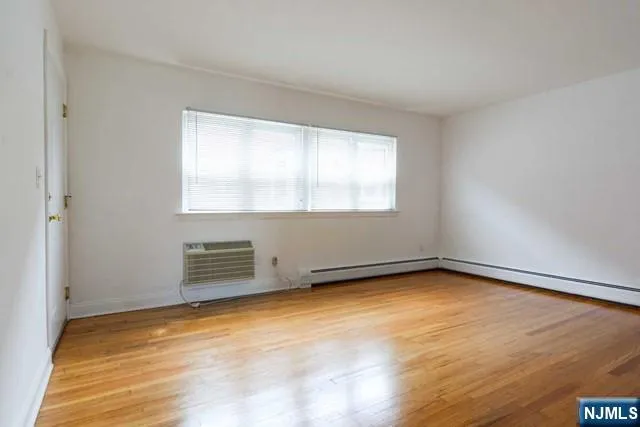 an empty room with a empty space and a window