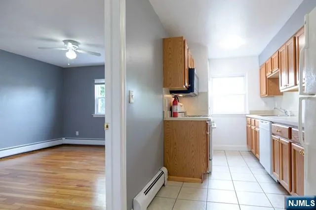 a kitchen with a refrigerator and a stove top oven
