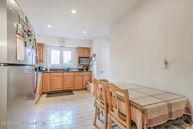 a kitchen with stainless steel appliances granite countertop a refrigerator sink and cabinets