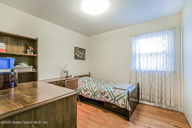 a bedroom with double bed and a dresser
