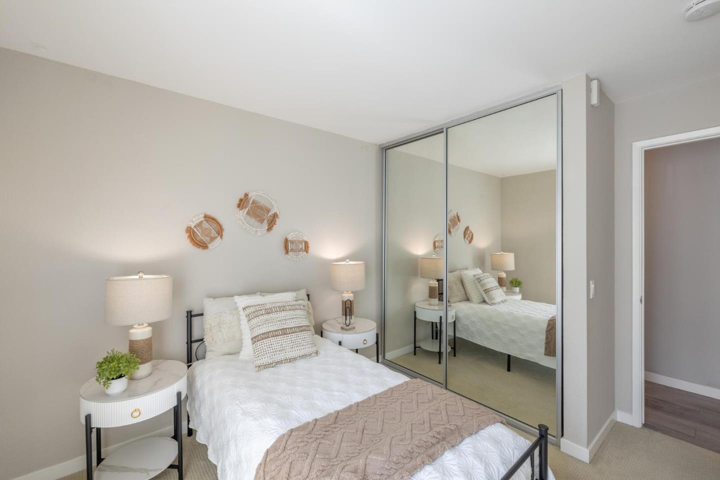 360 Vallejo Drive, Unit 98 Millbrae, CA 94030 - Photo 21 of 32 a bedroom with a bed and a chandelier