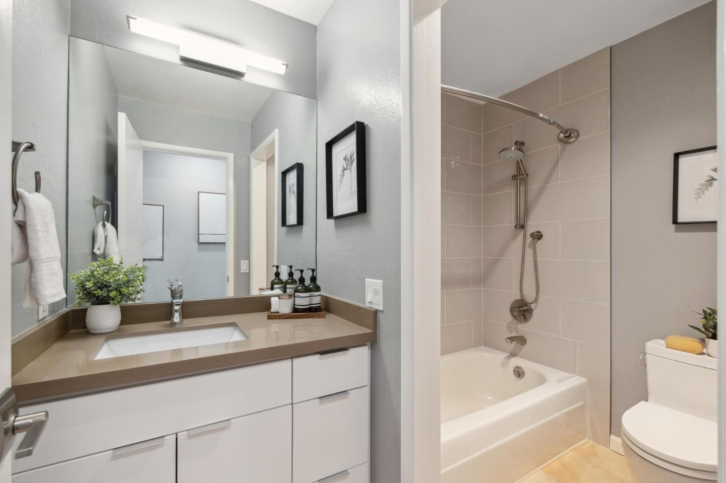 360 Vallejo Drive, Unit 98 Millbrae, CA 94030 - Photo 22 of 32 a bathroom with a tub a sink and a large mirror