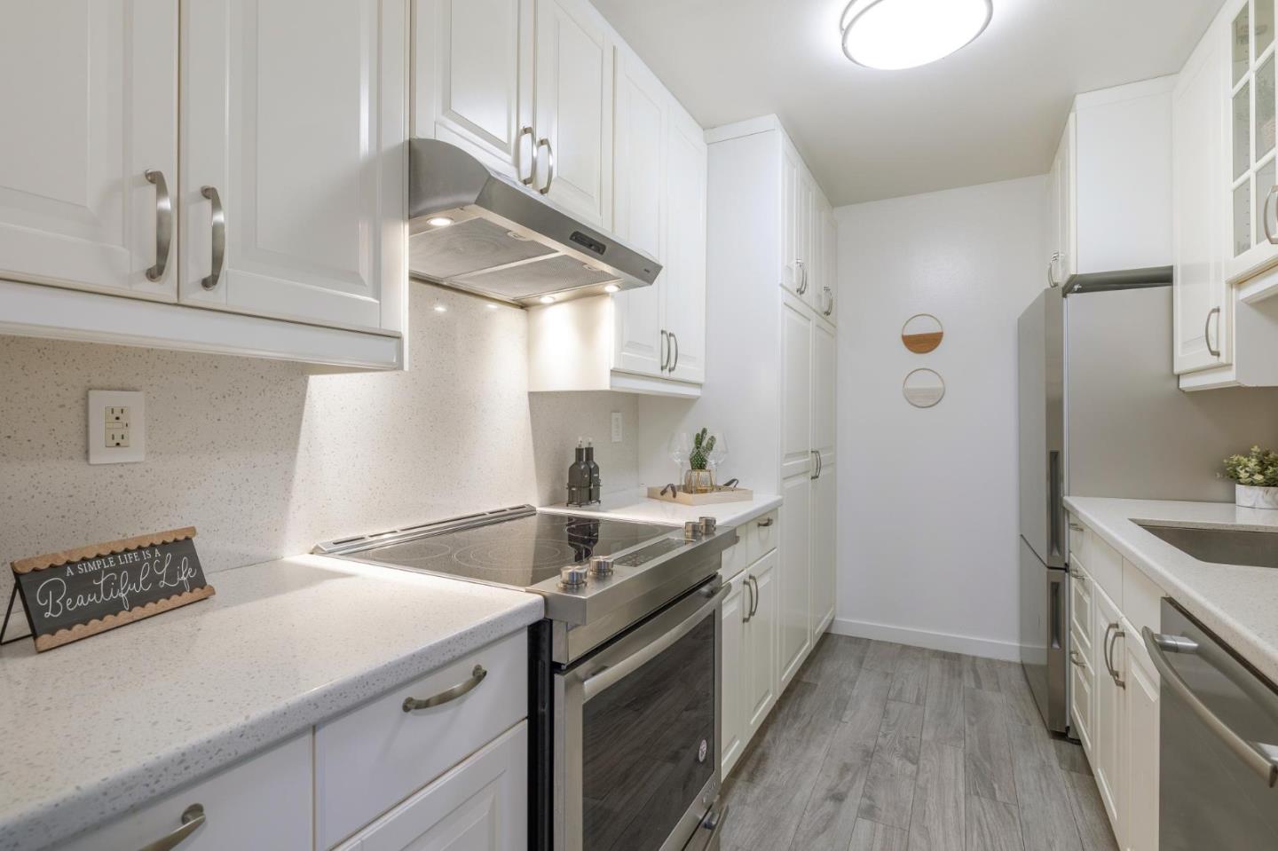 360 Vallejo Drive, Unit 98 Millbrae, CA 94030 - Photo 10 of 32 a kitchen with a sink stove and cabinets