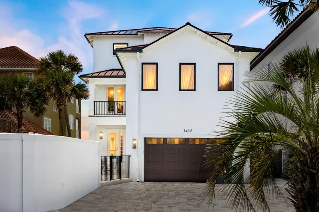 a view of a house with a palm tree