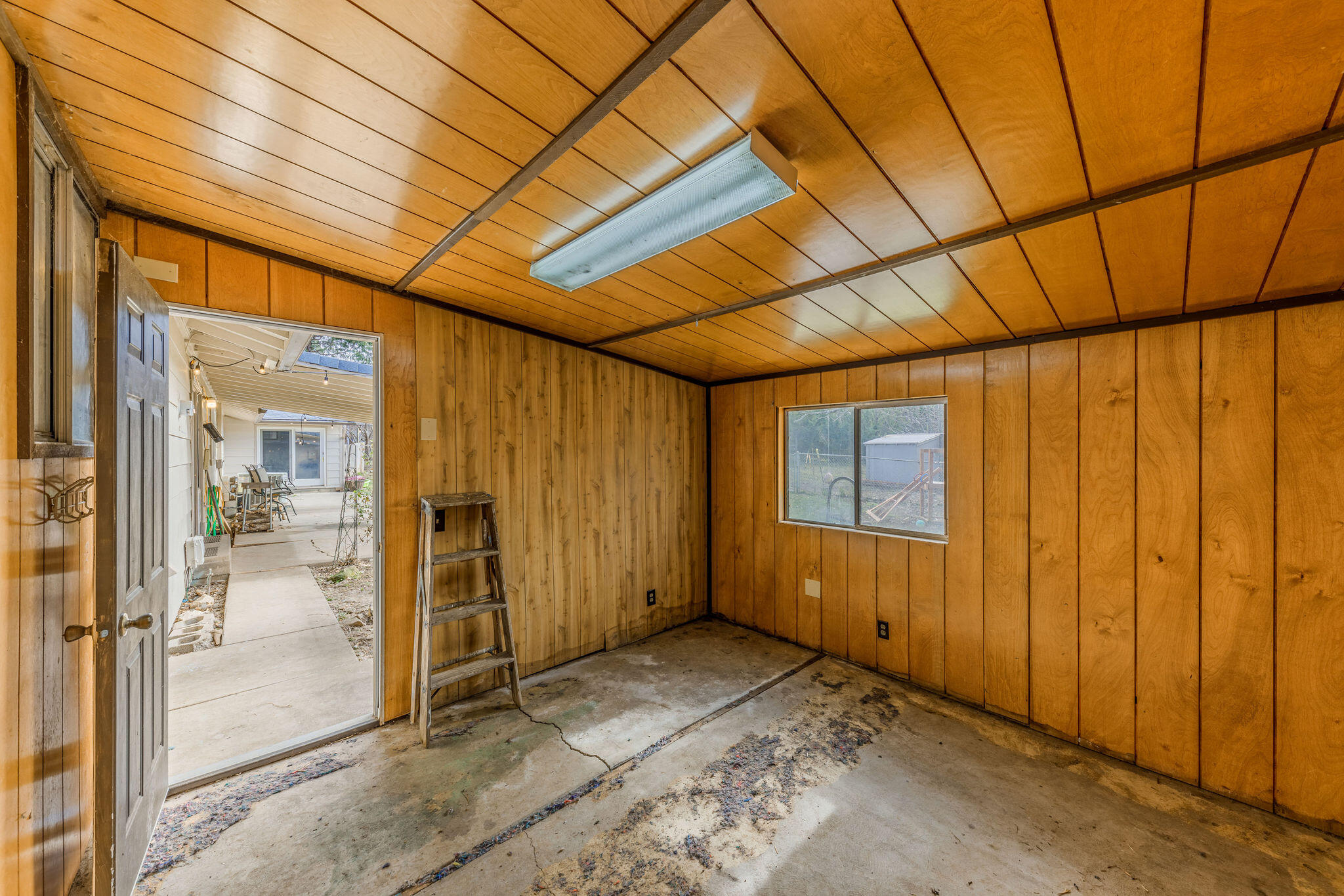 6732 Old Stage Road Central Point, OR 97502 - Photo 37 of 51 a view of a room with an empty space and wooden walls