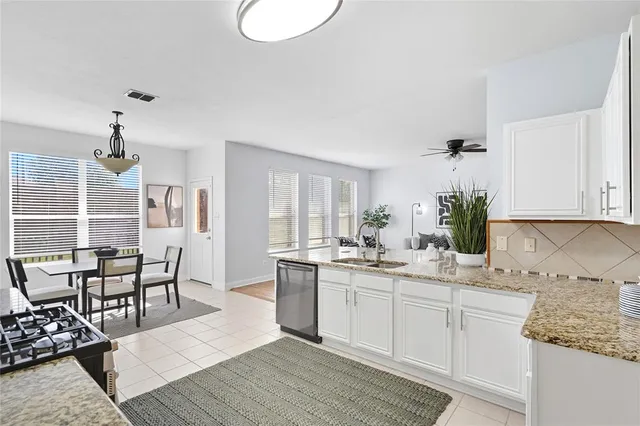 a kitchen with a sink cabinets and window