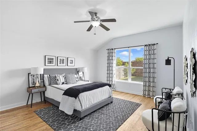 a bedroom with a bed wooden floor and a table