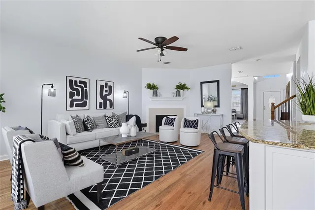 a living room with furniture a fireplace and a table