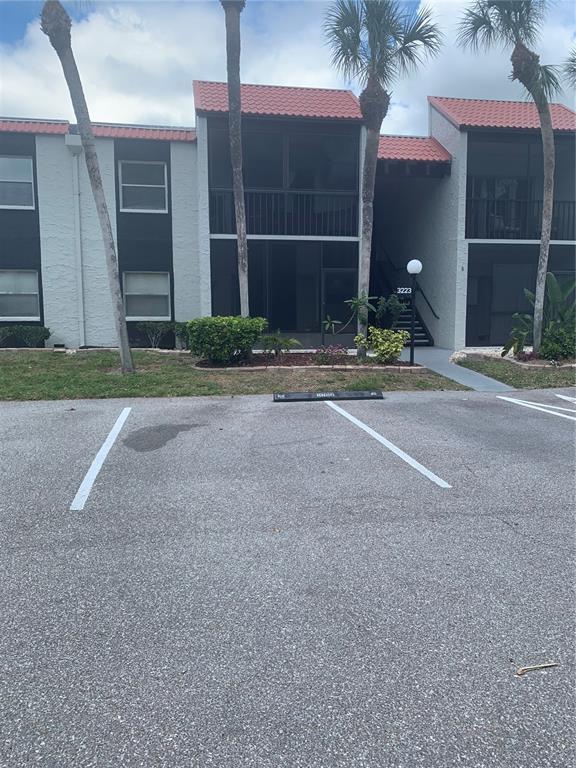 3223 South Beneva Road, Unit 103 Sarasota, FL 34232 - Photo 1 of 17 a view of a house with backyard and parking space