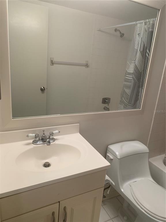 3223 South Beneva Road, Unit 103 Sarasota, FL 34232 - Photo 11 of 17 a white toilet sitting next to a bathroom sink