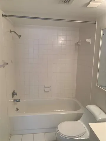 a bathroom with a sink a toilet and bathtub