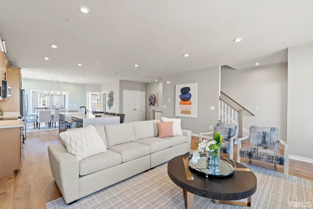a bedroom with a large bed and paintings on the wall