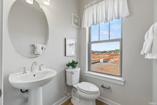 a bathroom with a shower sink and mirror