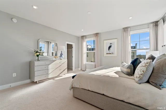 a bathroom with a sink a toilet and a large mirror