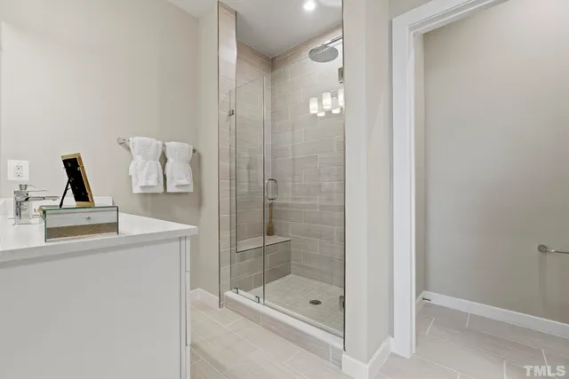 a roof deck with couches and potted plants