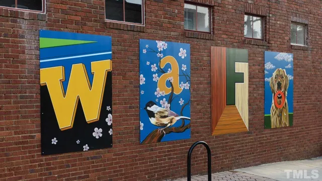 a view of a building with a car parked on the road