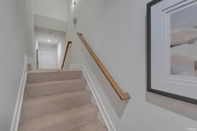 a view of staircase with white walls and a window