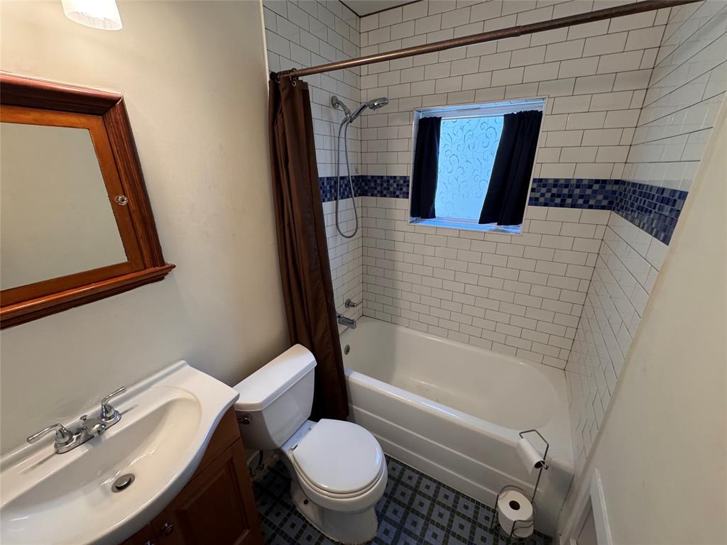 2547 Sharon Street Dallas, TX 75211 - Photo 13 of 22 a bathroom with a sink toilet and shower