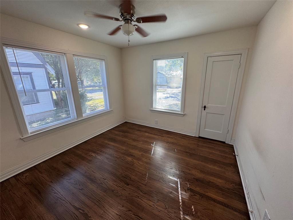 2547 Sharon Street Dallas, TX 75211 - Photo 15 of 22 a view of an empty room with wooden floor and a window