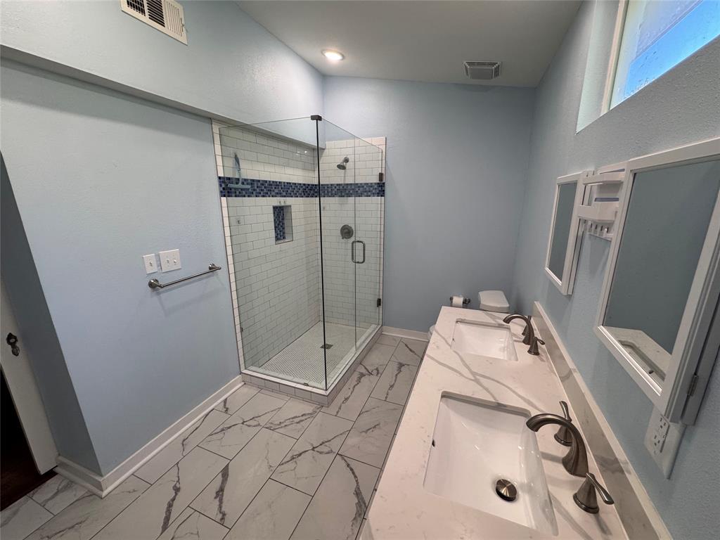 2547 Sharon Street Dallas, TX 75211 - Photo 19 of 22 a bathroom with a sink a toilet and shower