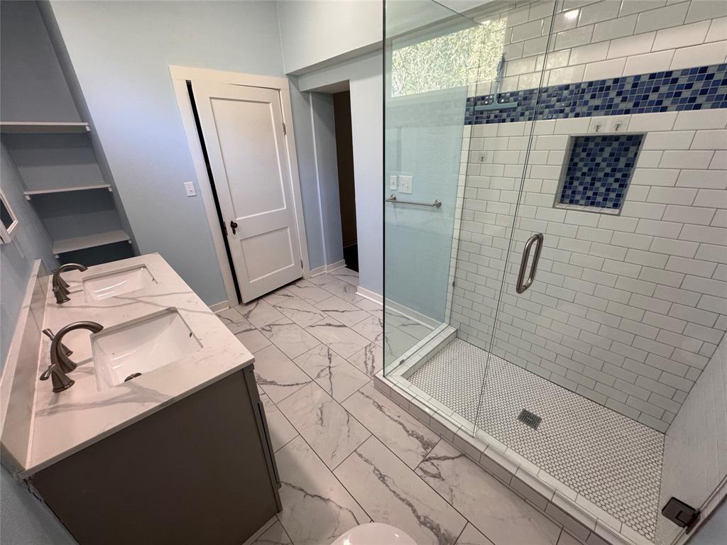 2547 Sharon Street Dallas, TX 75211 - Photo 20 of 22 a bathroom with a sink toilet and shower
