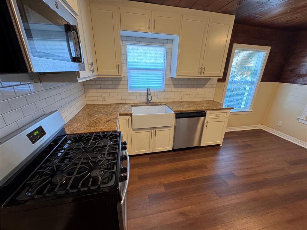 2547 Sharon Street Dallas, TX 75211 - Photo 6 of 22 a kitchen with granite countertop a stove and a sink