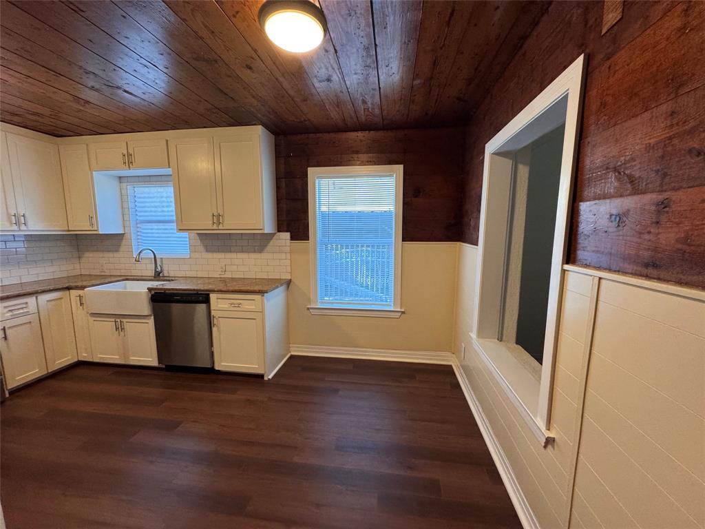 2547 Sharon Street Dallas, TX 75211 - Photo 8 of 22 a kitchen with stainless steel appliances granite countertop a refrigerator a sink dishwasher a stove and white countertops with wooden floor