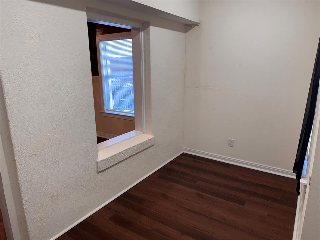 2547 Sharon Street Dallas, TX 75211 - Photo 9 of 22 a small space with wooden floor and mirror