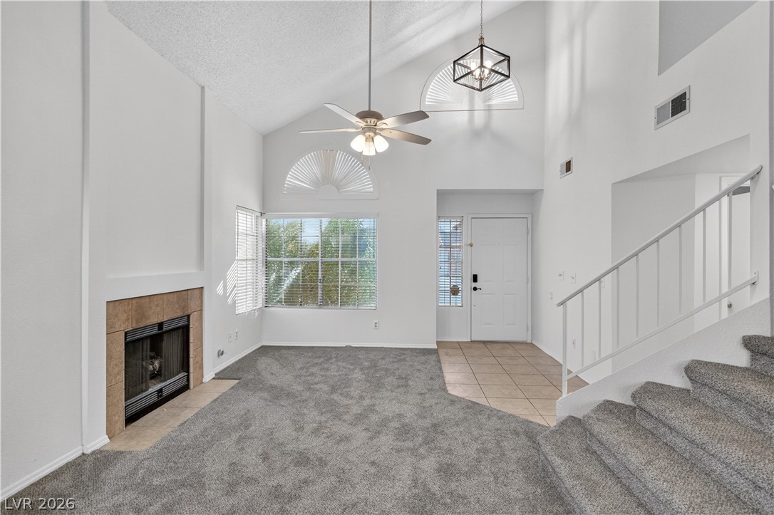 3156 Terrace View Drive Laughlin, NV 89029 - Photo 6 of 94 A striking two-story living area features a grand fireplace, tall ceilings, and abundant natural light.