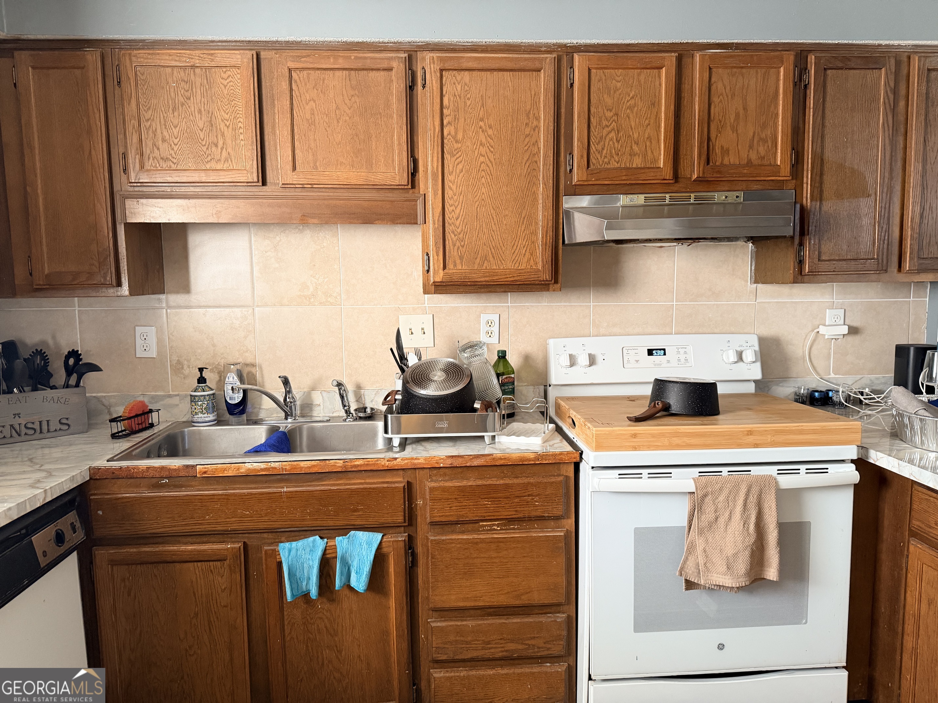 3484 Blazing Pine Path Decatur, GA 30034 - Photo 7 of 10 a kitchen with stainless steel appliances granite countertop a sink stove and cabinets
