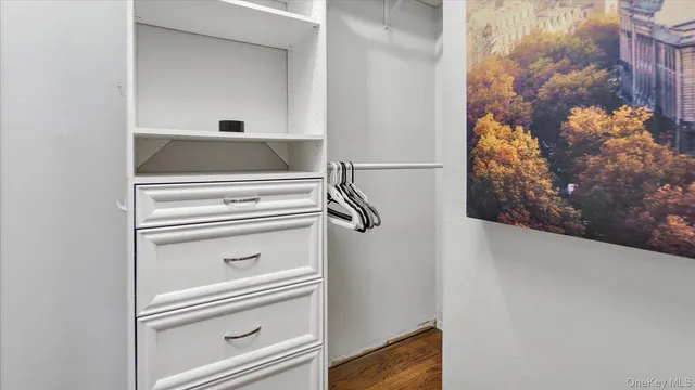 a view of a bedroom with furniture and wooden floor
