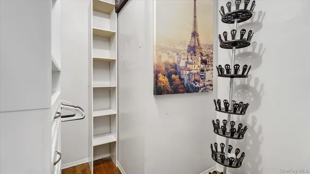a view of an entryway with wooden floor and cabinets