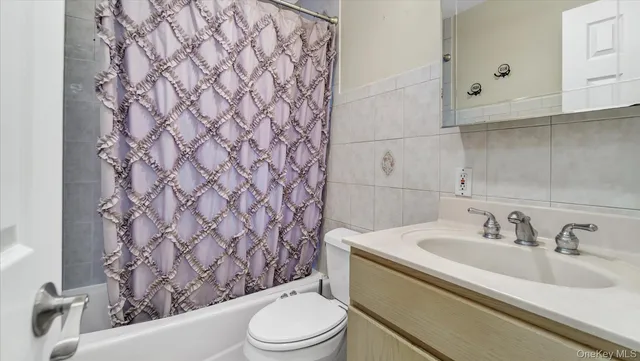 a view of an empty room with wooden floor and closet
