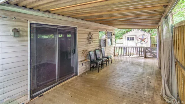a view of a small house in a yard with wooden fence