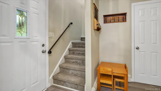 a view of a hallway with wooden floor and entryway