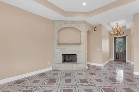 a open kitchen with stainless steel appliances granite countertop a refrigerator a sink a stove and oven with wooden floor