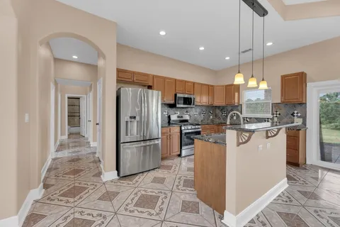 a lobby with furniture and chandelier