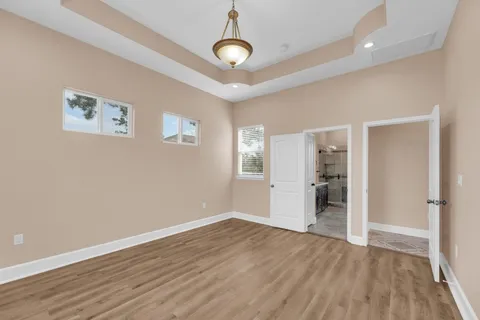 a view of an empty room with a fireplace and a window