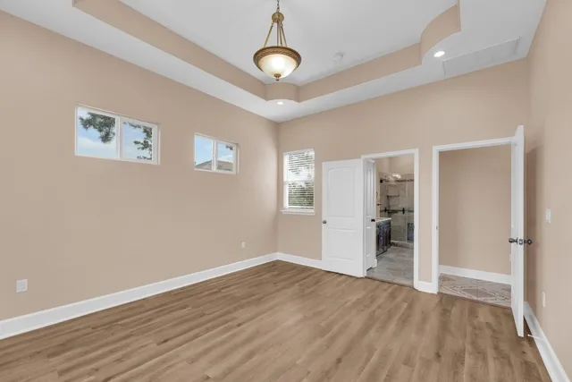 a view of an empty room with a fireplace and a window