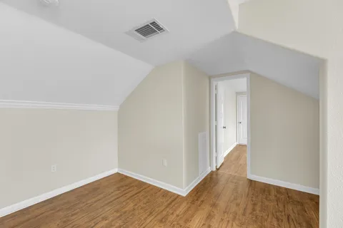 a view of a livingroom with wooden floor and a window