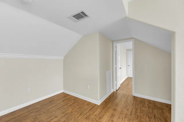 a view of a livingroom with wooden floor and a window