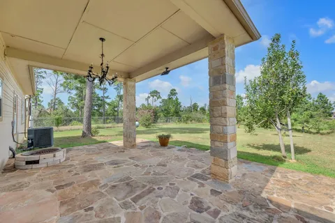 a view of a house with backyard porch and garden