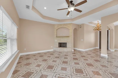 a view of an empty room with a fireplace