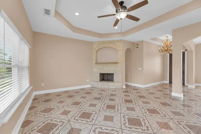 a view of an empty room with a fireplace