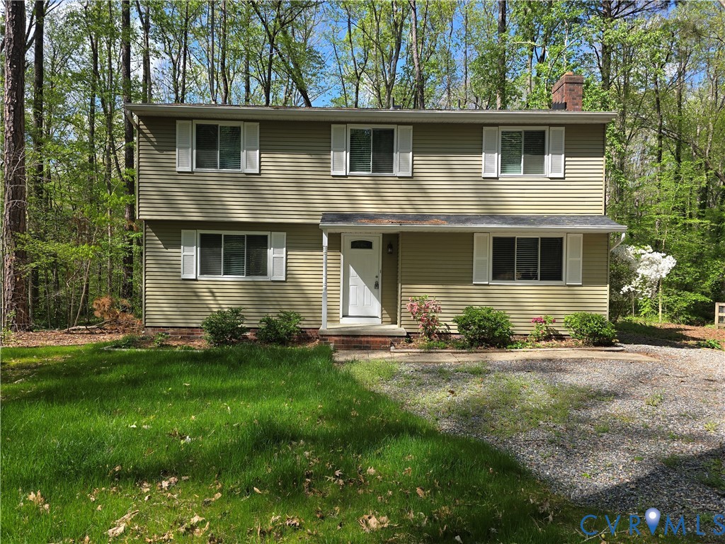 4600 Painted Post Lane Midlothian, VA 23112 - Photo 1 of 44 a front view of a house with a garden